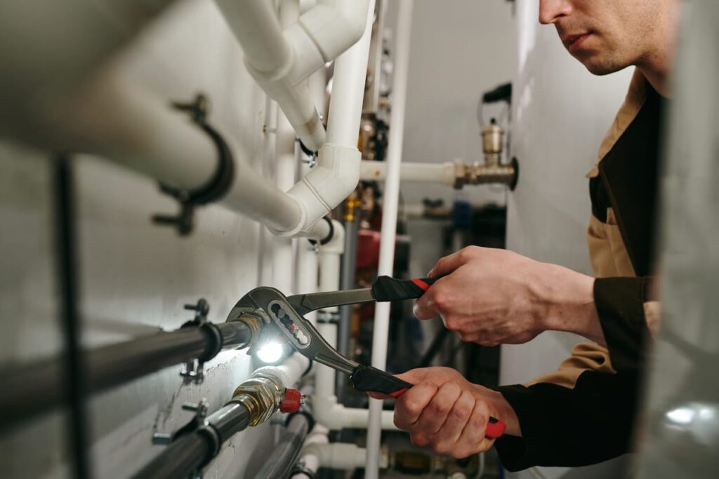 Plumbers maintaining commercial plumbing pipes in Indio